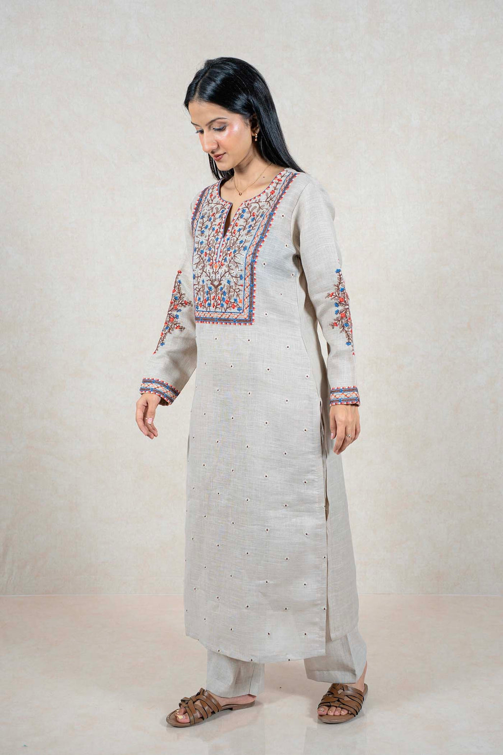 Raysham Fashion beige linen kurta set with intricate blue, orange, and brown floral embroidery on neckline and sleeves.