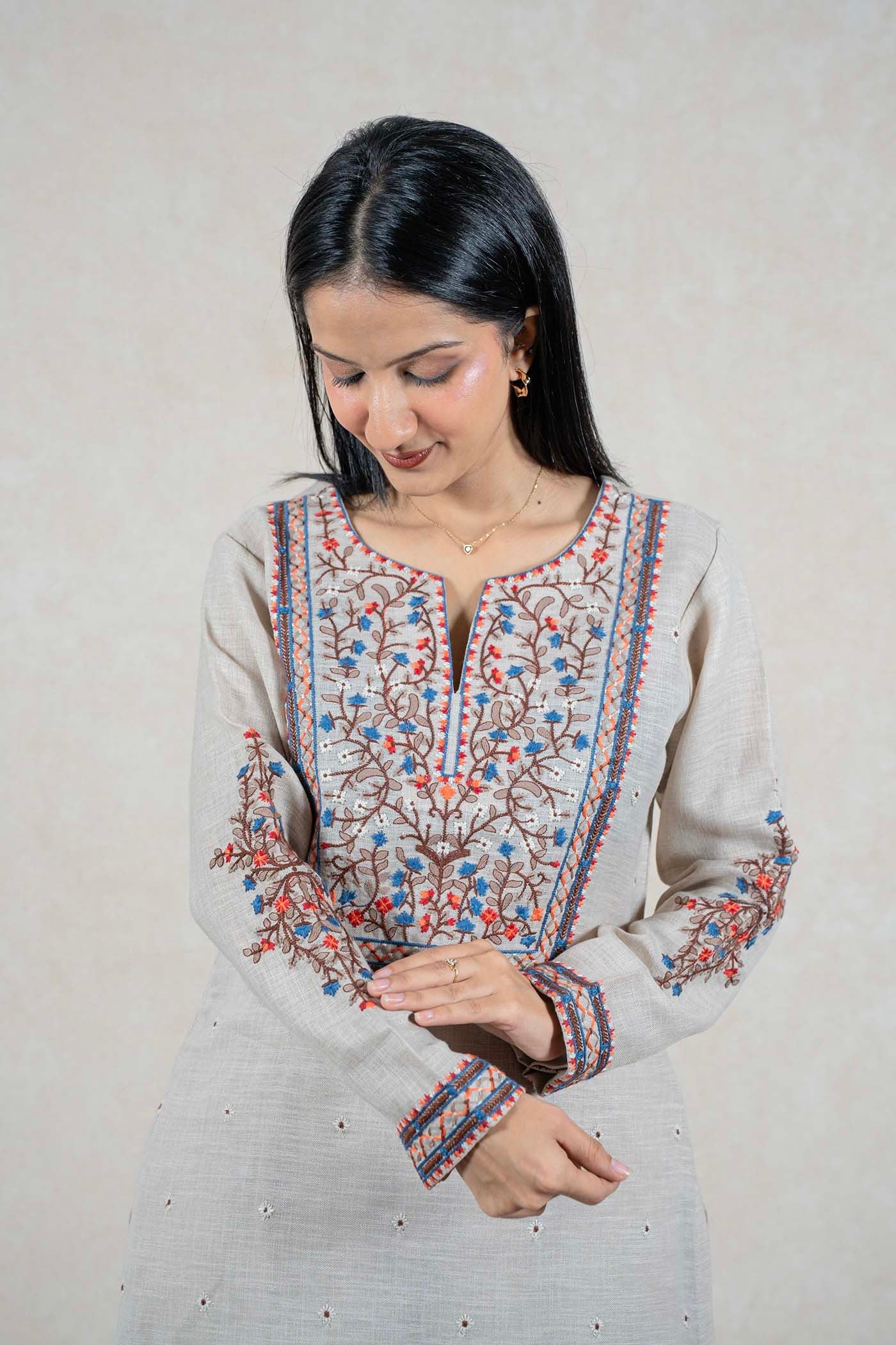 Raysham Fashion beige linen kurta with intricate blue, orange, and brown floral embroidery on neckline and sleeves.