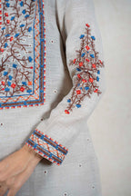 Raysham Fashion beige linen kurta featuring intricate blue, orange, and brown floral embroidery on neckline and sleeves