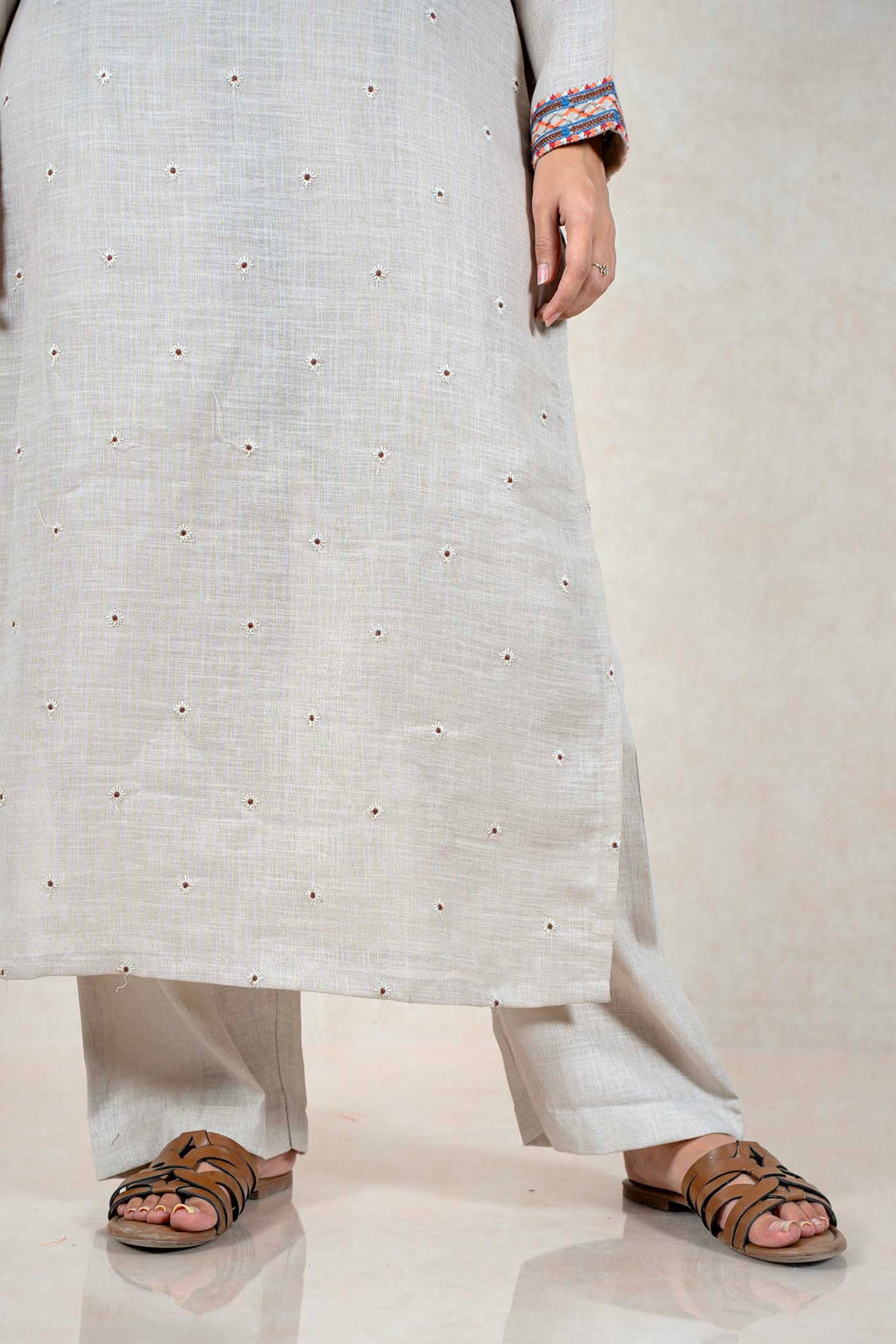 Raysham Fashion beige linen kurta set with intricate floral embroidery on sleeves and scattered motifs on the body