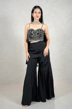 Raysham Fashion black co-ord set with embroidered bustier crop top and high-waisted wide-leg trousers on a model.