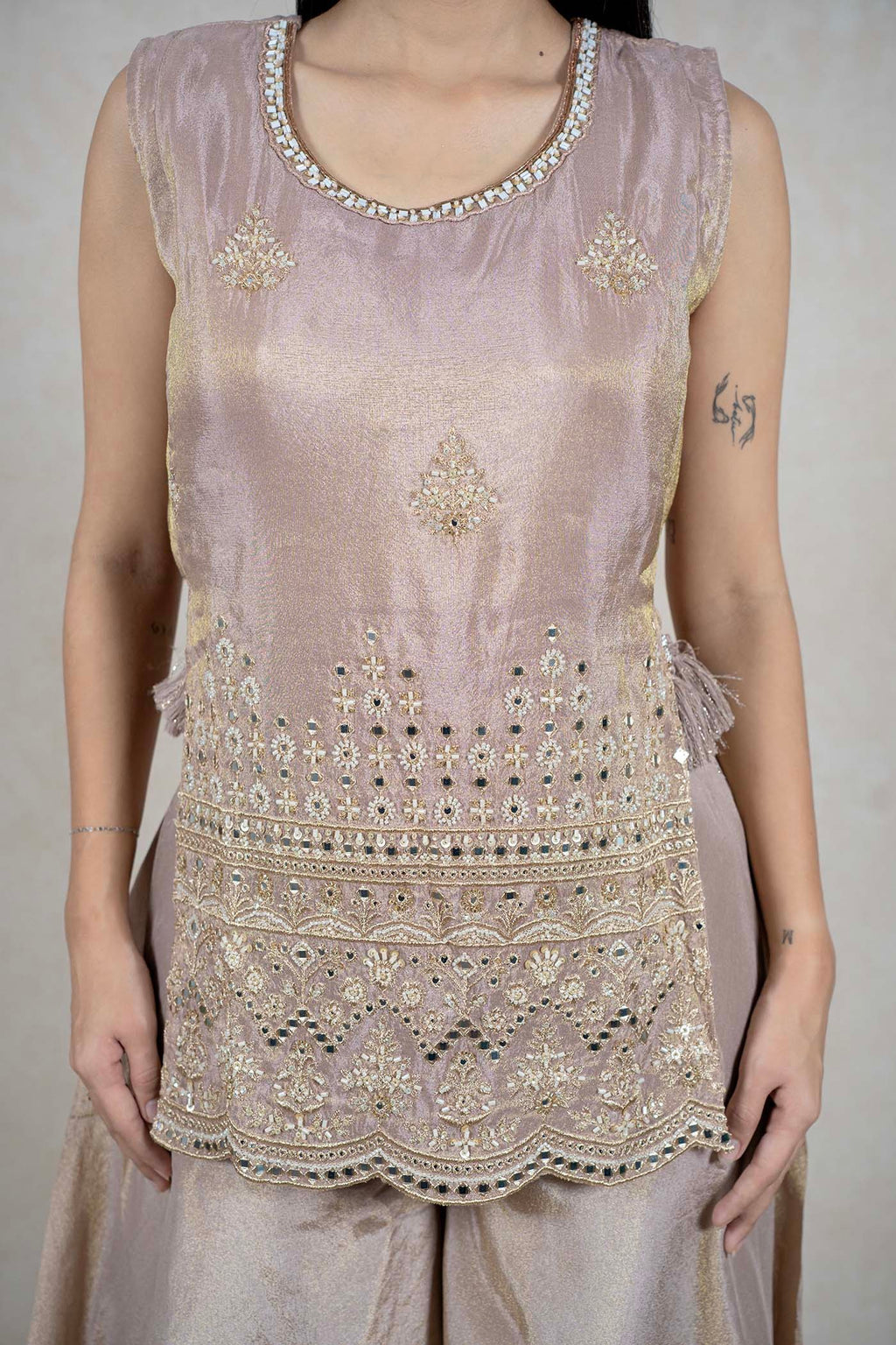 Raysham Fashion champagne sleeveless kurta with intricate mirror work, embroidery, and a scalloped hemline.