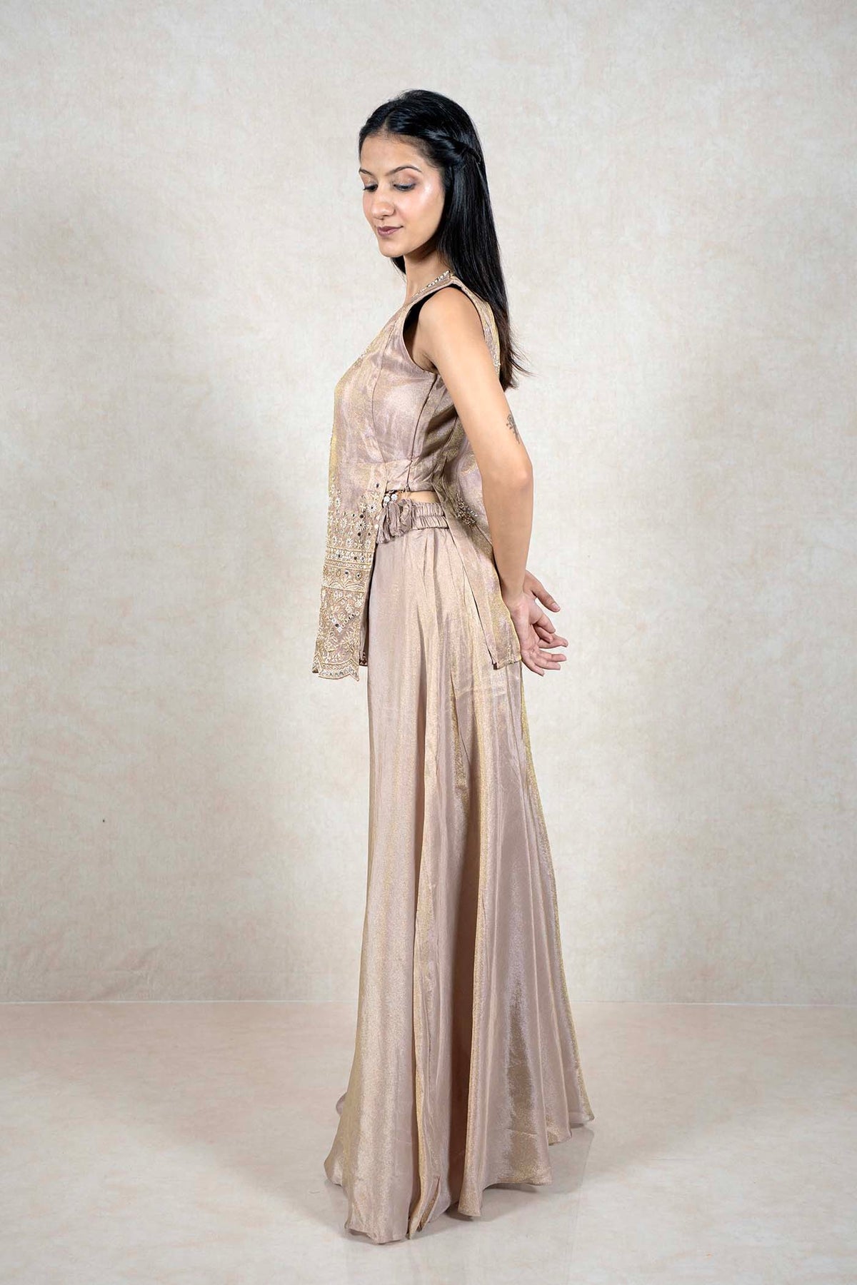 Raysham Fashion champagne sleeveless kurta with mirror work and wide-leg palazzo pants on a model, side profile view.