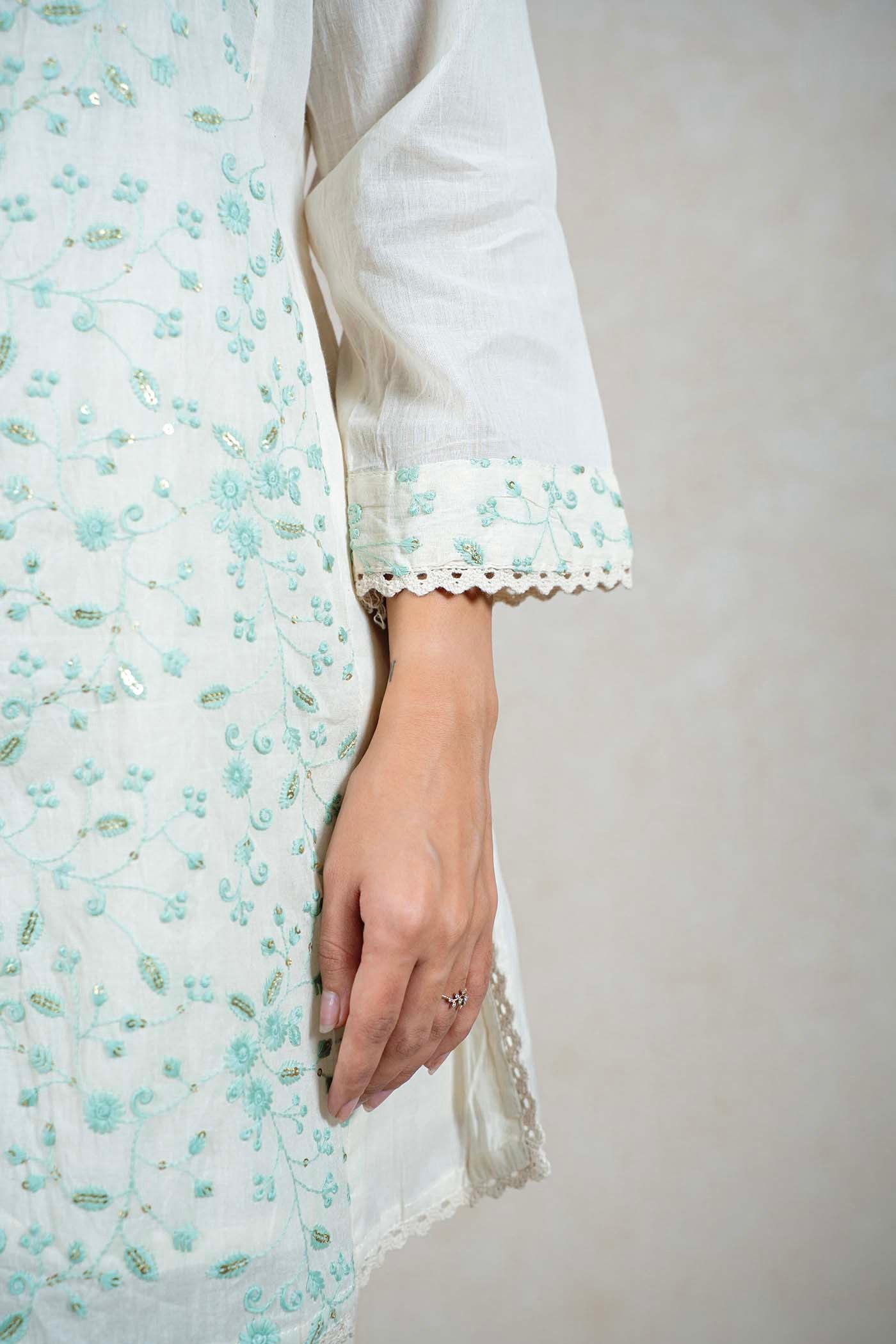 Raysham Fashion off-white cotton kurta with mint green floral embroidery, sequin accents, and scalloped lace cuffs.