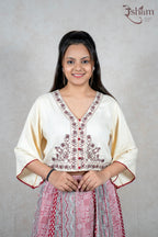 Raysham Fashion off-white embroidered crop top with V-neck and flared sleeves paired with a printed red ethnic skirt