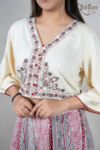 Raysham Fashion off-white crop top with floral embroidery and V-neck, paired with a printed red ethnic skirt.