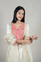 Raysham Fashion off-white silk-blend kurta set with coral-pink embroidered bodice, sequins, and mirror work details.