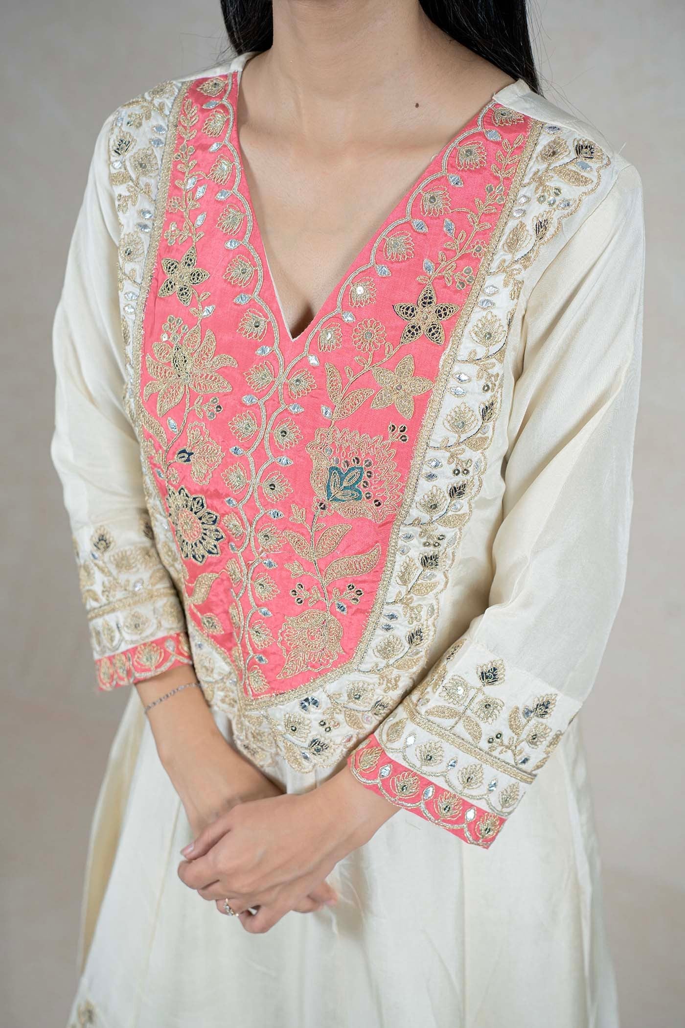 Raysham Fashion off-white silk-blend kurta with coral-pink floral embroidery, sequins, and mirror work on the bodice.