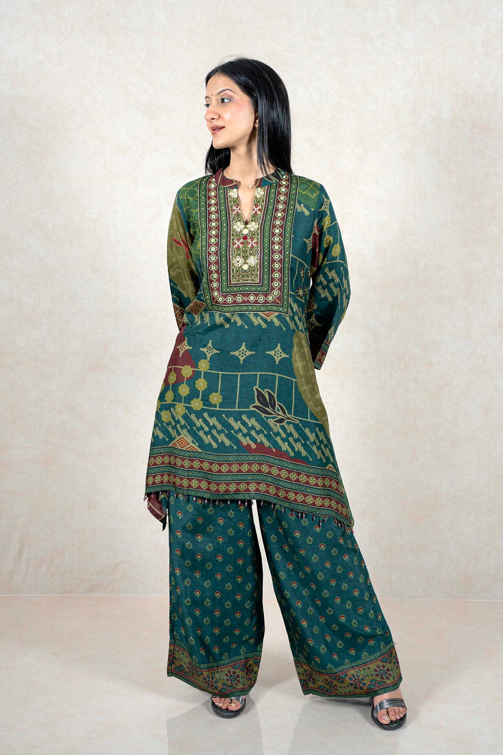 Raysham Fashion emerald green printed kurta and wide-leg pant set with mirror work and embroidery on the neckline.