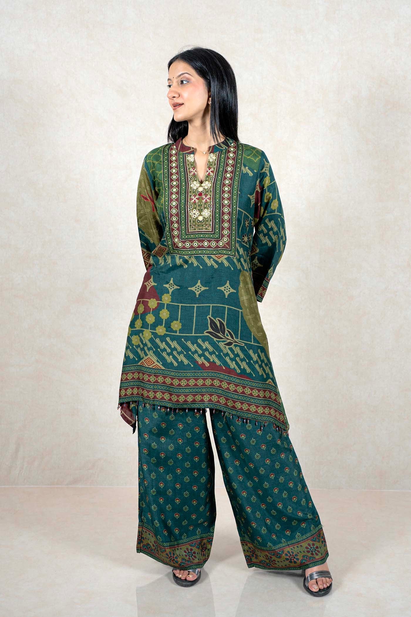 Raysham Fashion emerald green printed kurta and wide-leg pant set with mirror work and embroidery on the neckline.