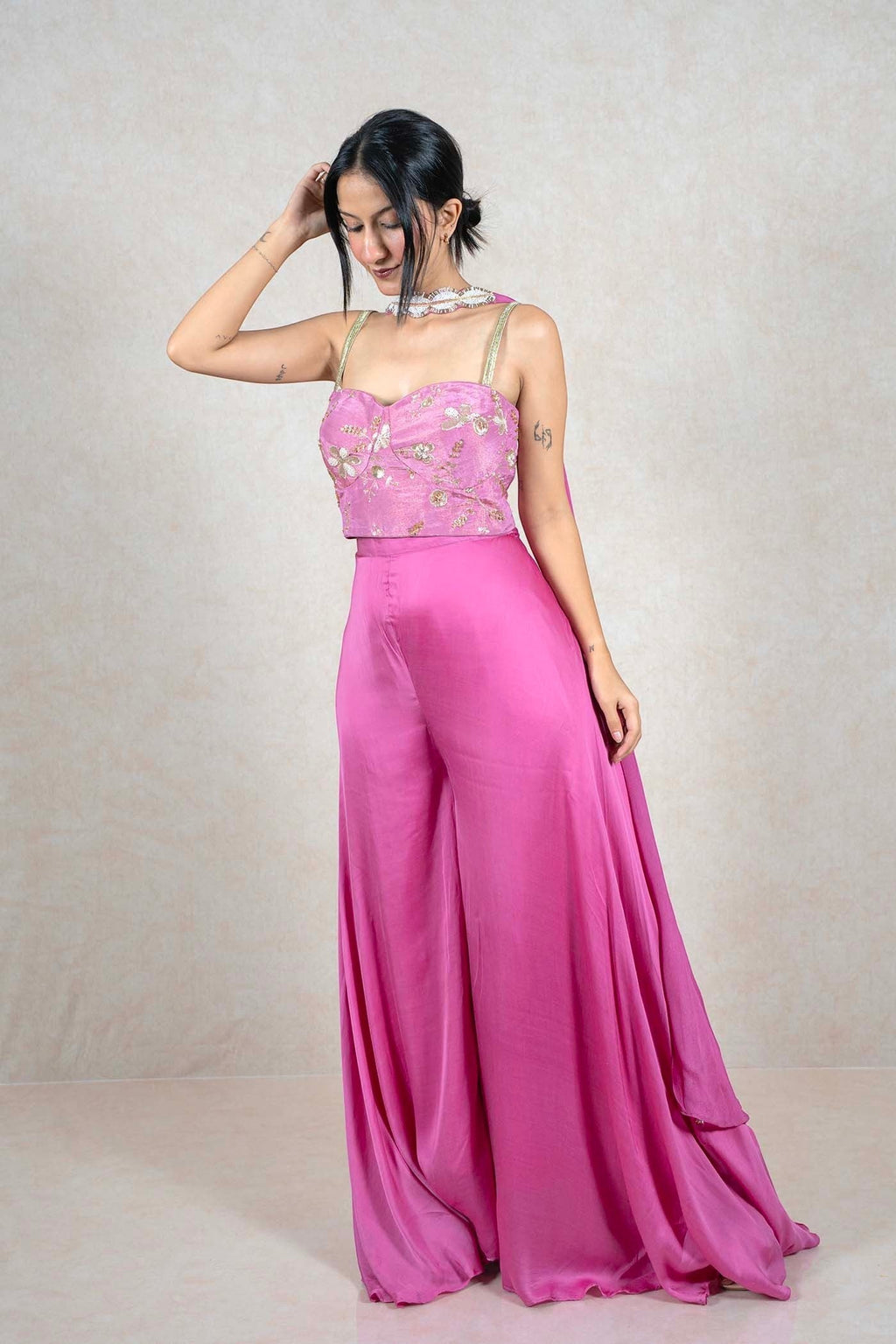 Raysham Fashion fuchsia pink jumpsuit with an embellished corset bodice, gold floral embroidery, and wide-leg trousers.