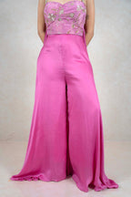 Raysham Fashion fuchsia pink jumpsuit with an embellished corset bodice featuring gold floral embroidery and wide legs.