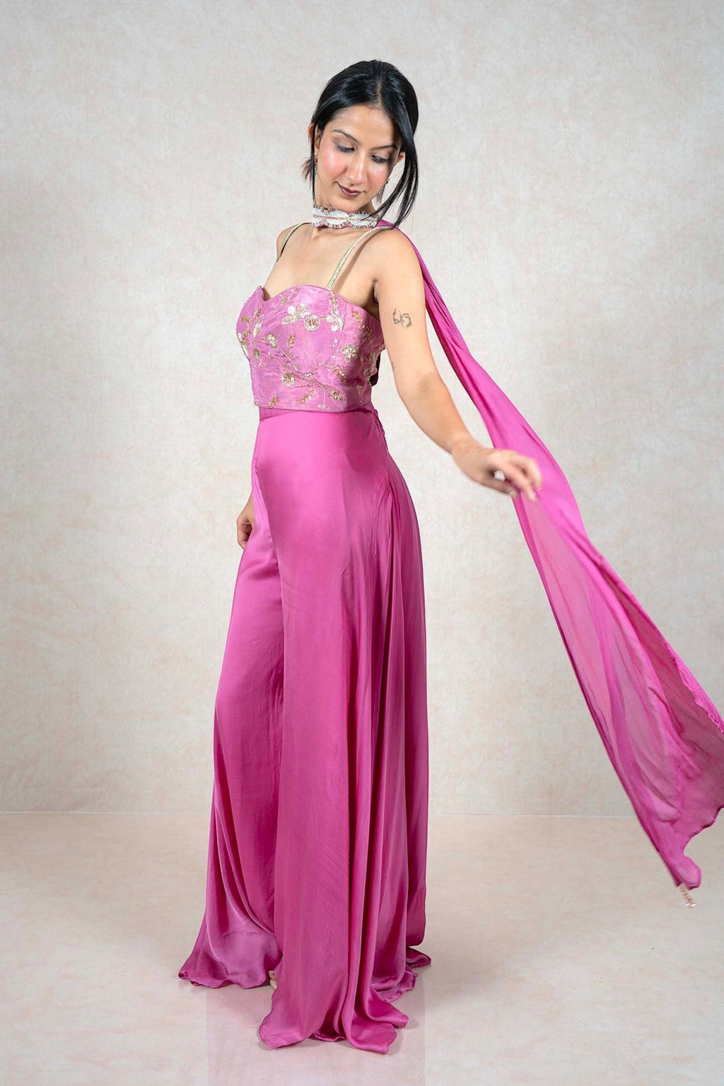Raysham Fashion fuchsia pink jumpsuit with gold embroidered corset bodice, wide-leg trousers, and flowing shoulder drape