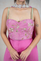 Raysham Fashion fuchsia pink corset jumpsuit with gold floral embroidery, sequins, and a matching beaded neckpiece.