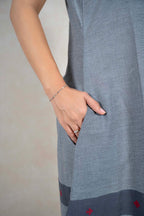 Raysham Fashion grey sleeveless cotton midi dress featuring a side pocket and a contrast hem with red embroidery.