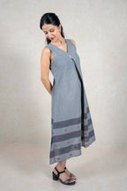Raysham Fashion sleeveless grey cotton midi dress with V-neck, central pleat, and striped hem with red embroidery.