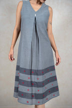 Raysham Fashion grey sleeveless cotton midi dress with V-neck, central pleat, and red diamond embroidery hem detail.