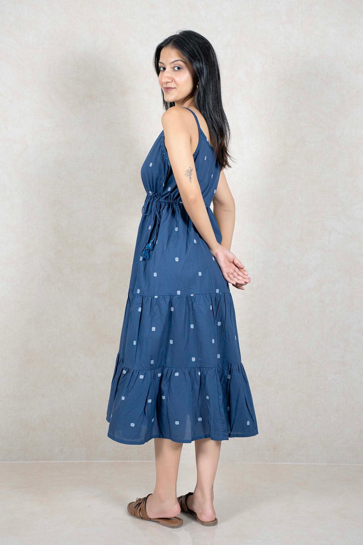 Woman wearing a Raysham Fashion indigo blue cotton tiered midi dress with a square print and drawstring waist