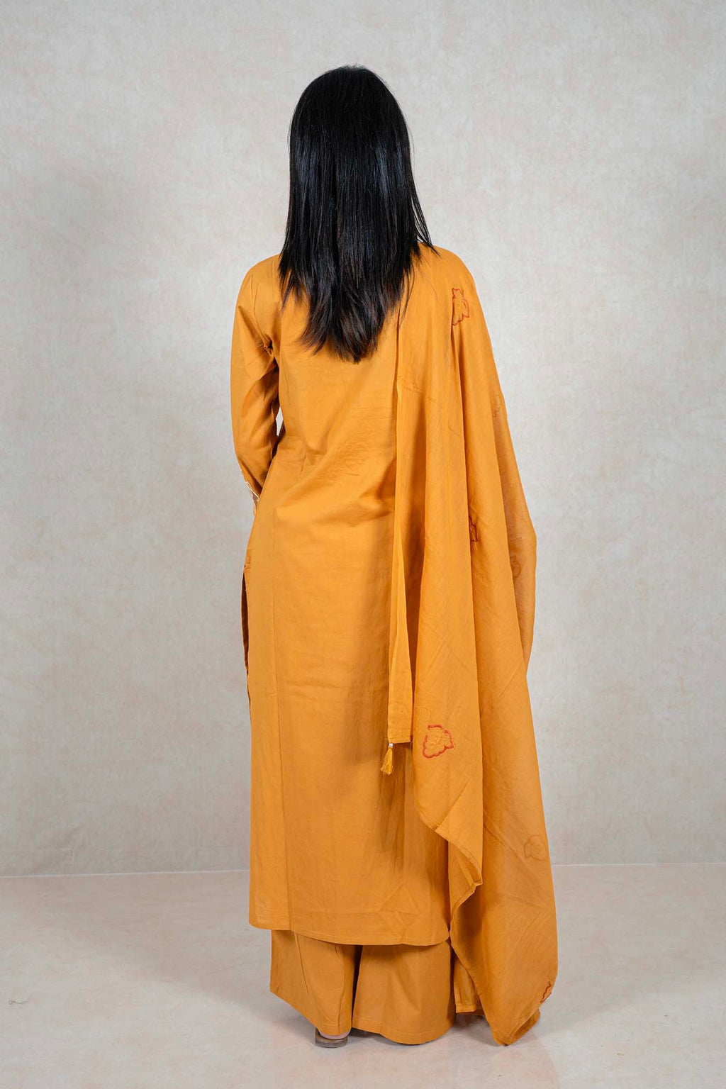 Back view of Raysham Fashion mustard yellow cotton kurta set with wide-leg trousers and matching embroidered dupatta