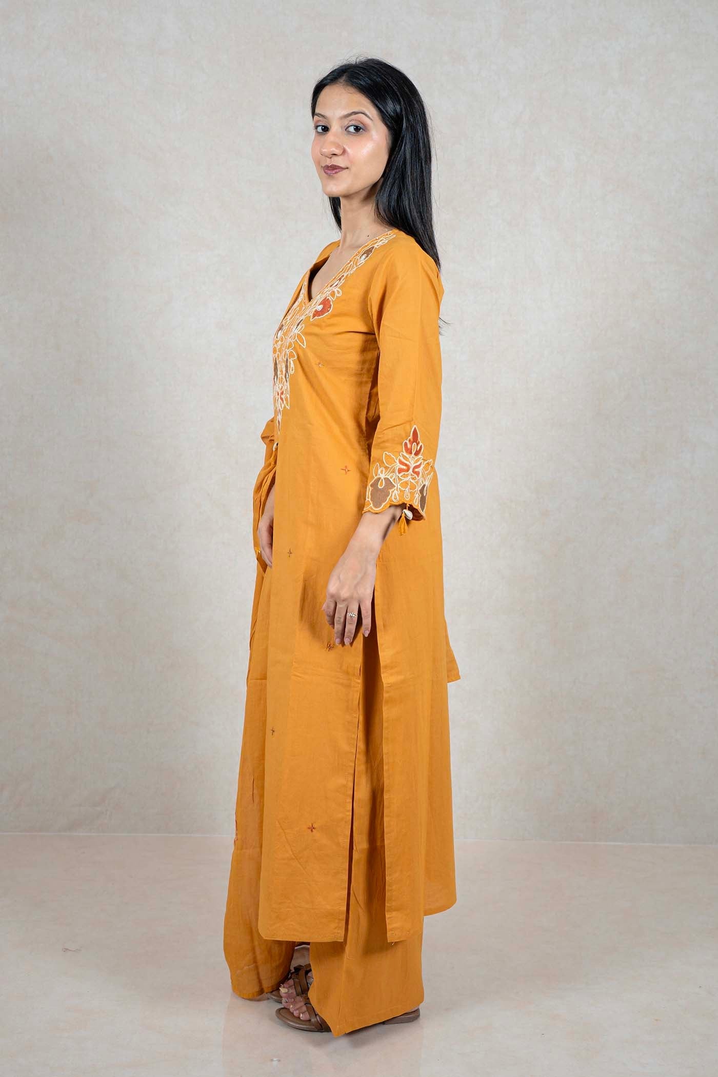 Raysham Fashion mustard yellow cotton kurta set with floral embroidery on V-neck and sleeves, side profile view.