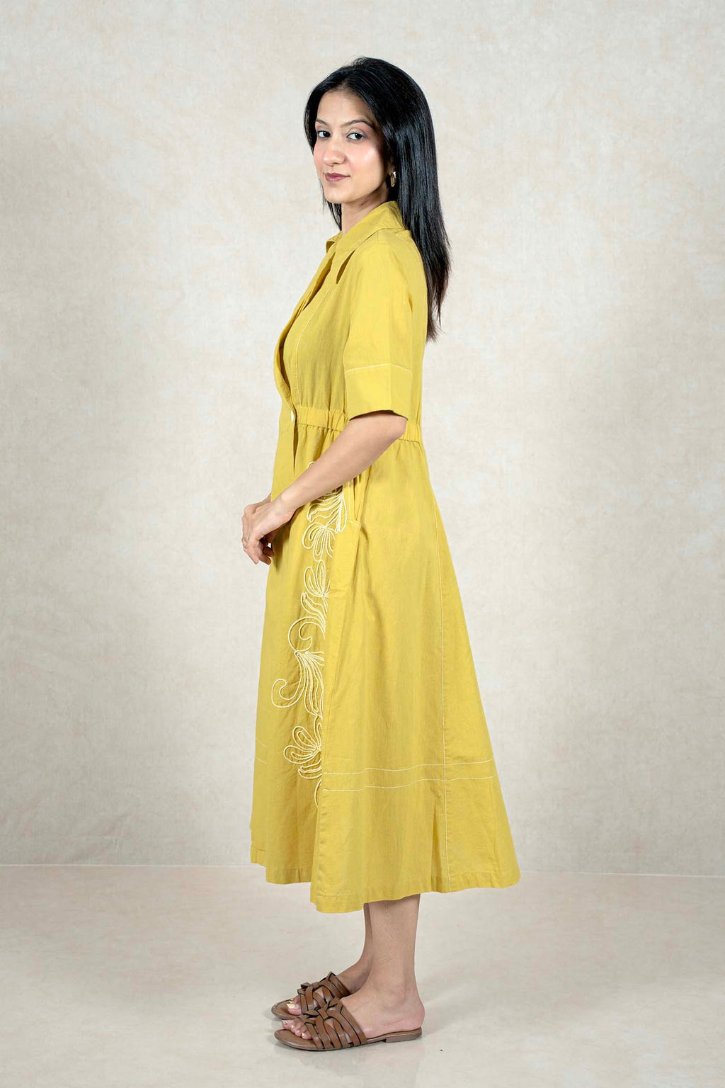 Raysham Fashion mustard yellow midi dress with white embroidery, lapel collar, and side pockets on a female model.