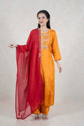 Raysham Fashion mustard yellow silk-blend kurta set with intricate embroidery and a sheer red dupatta