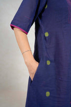 Raysham Fashion navy blue cotton midi dress with lime green polka dots, pink trim, and side pockets on a model
