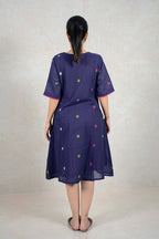 Back view of a Raysham Fashion navy blue cotton midi dress with a colorful polka dot pattern and pink sleeve trim.