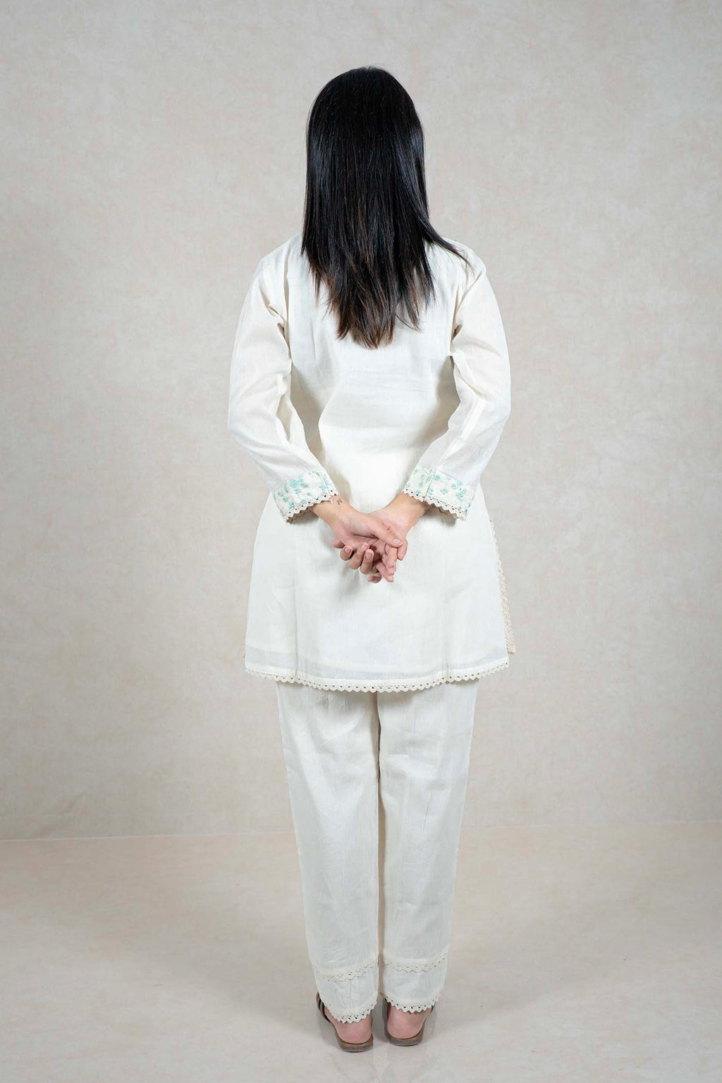 Raysham Fashion off-white cotton kurta set with mint green floral embroidery, scalloped lace trim, and trousers.