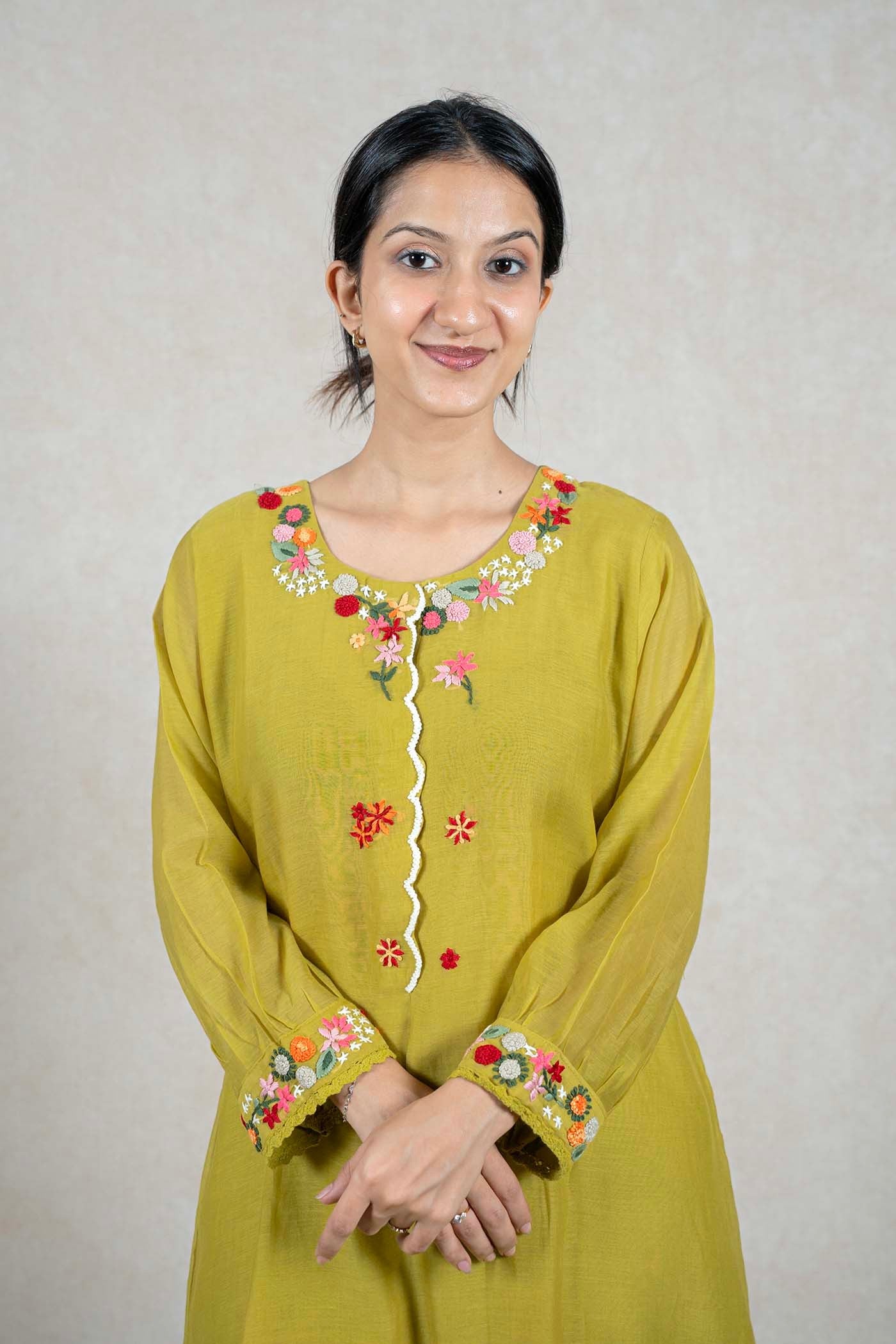Raysham Fashion olive green kurta with multi-colored floral embroidery on the neckline and cuffs and lace trim.