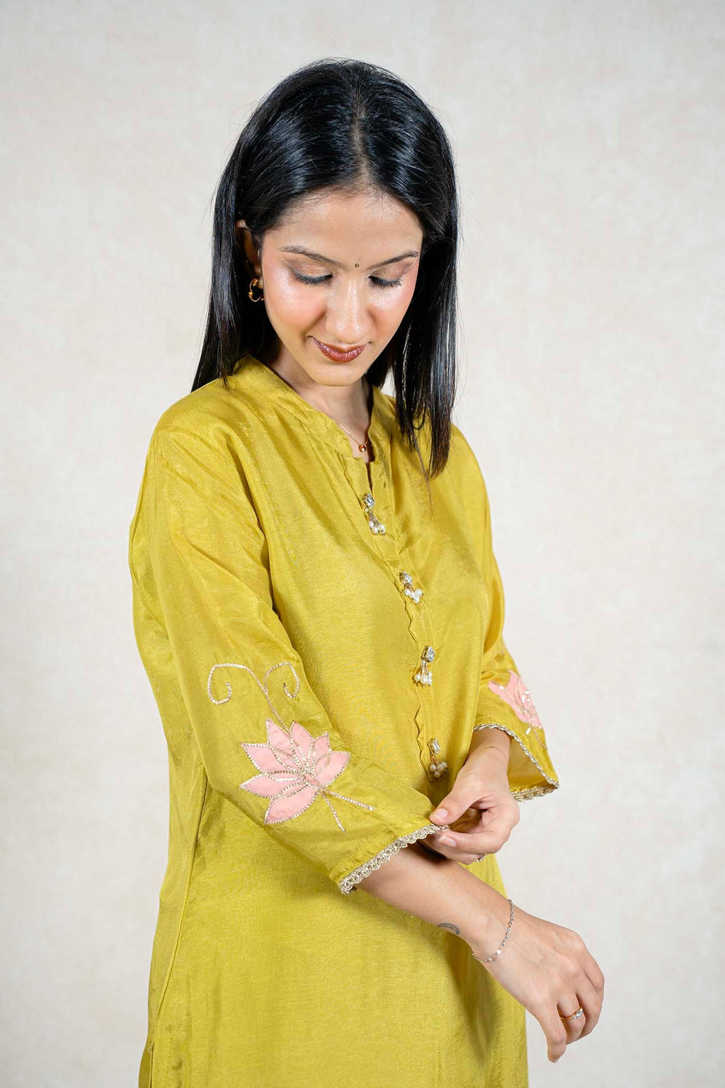 Raysham Fashion olive green silk kurta with pink floral embroidery, pearl embellishments, and three-quarter sleeves.