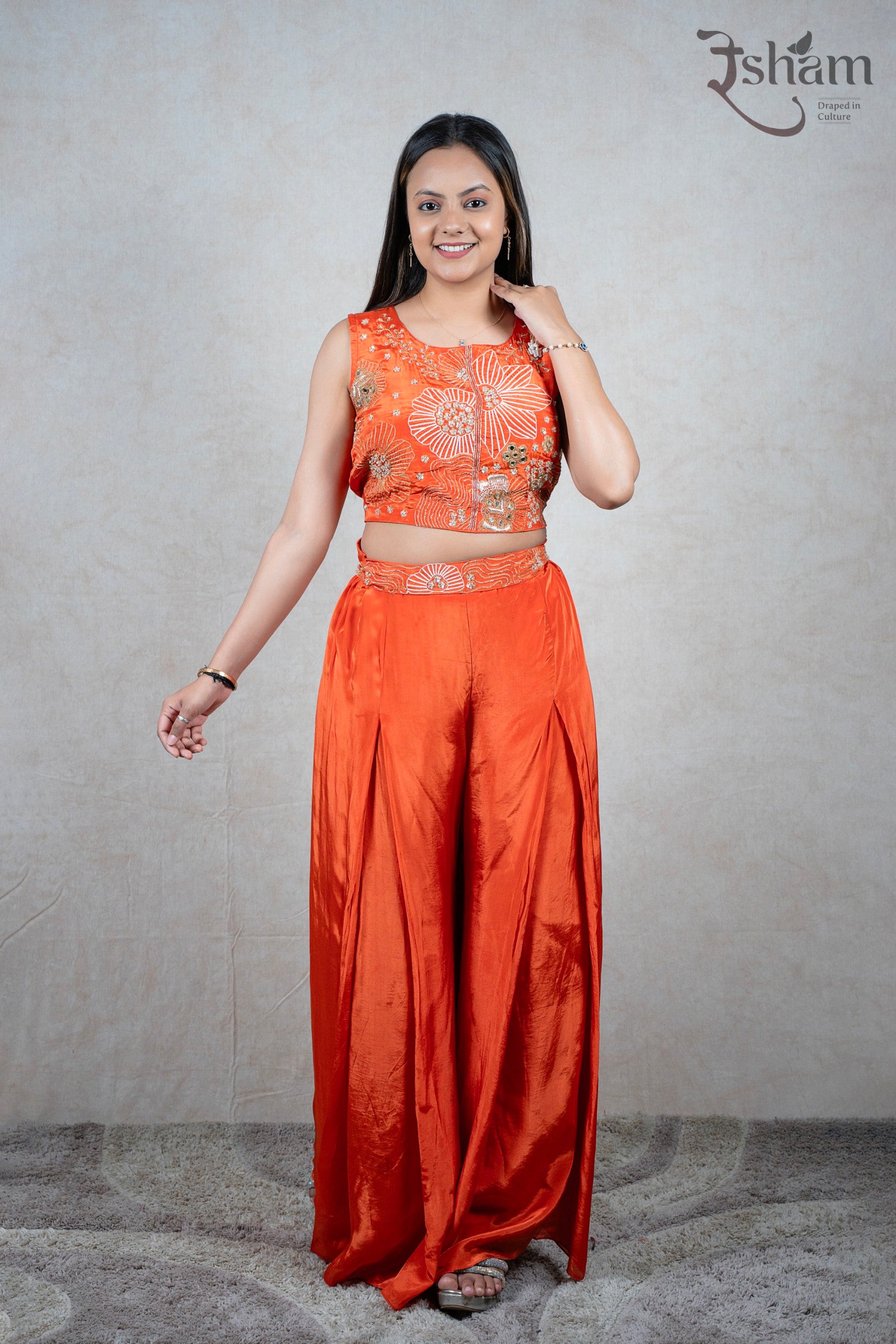 Raysham Fashion orange sleeveless crop top and wide-leg trouser set with floral embroidery and sequin detailing.