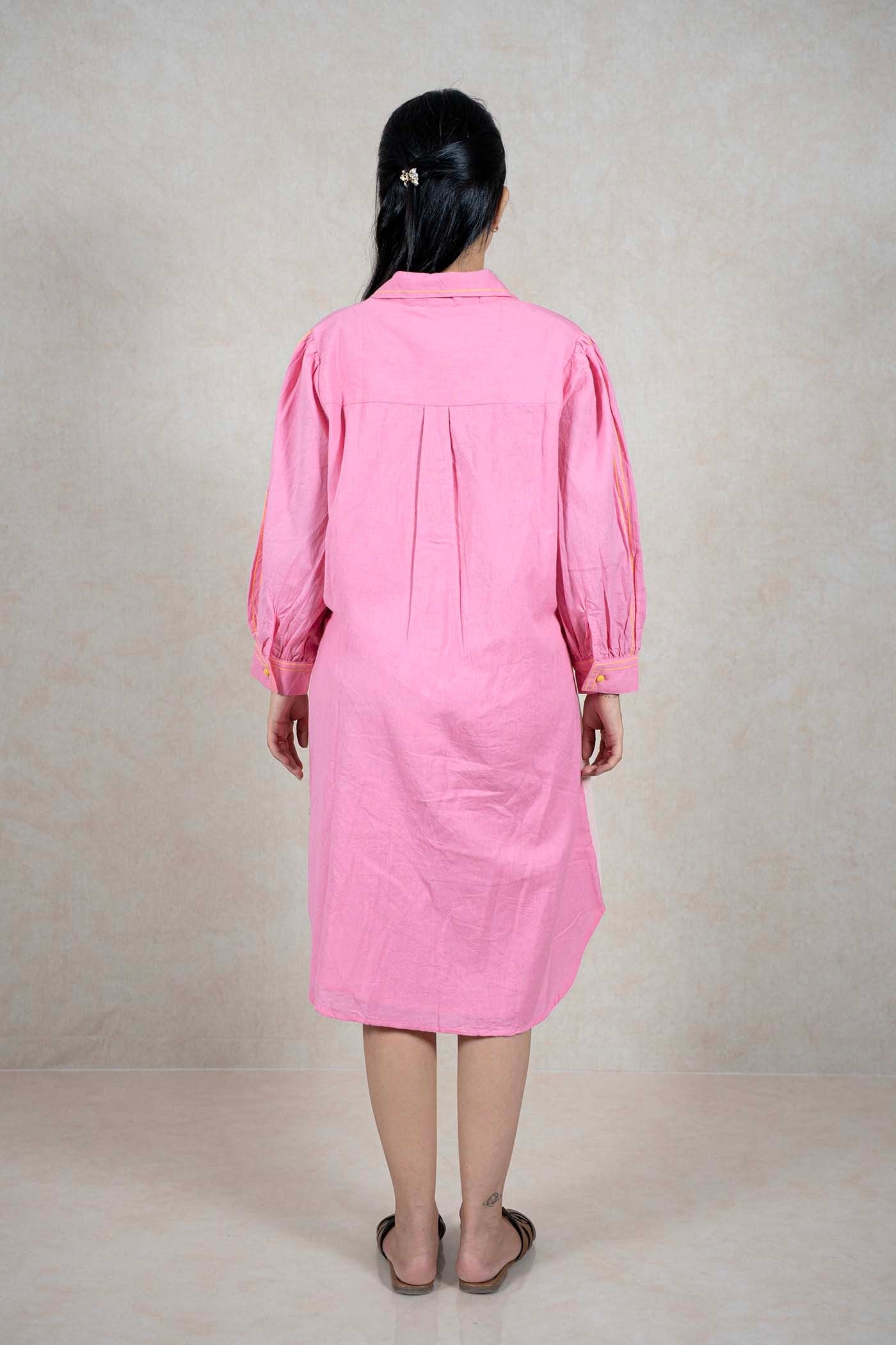 Back view of a model wearing a Raysham Fashion pink midi shirt dress with long sleeves and yellow stitching details.