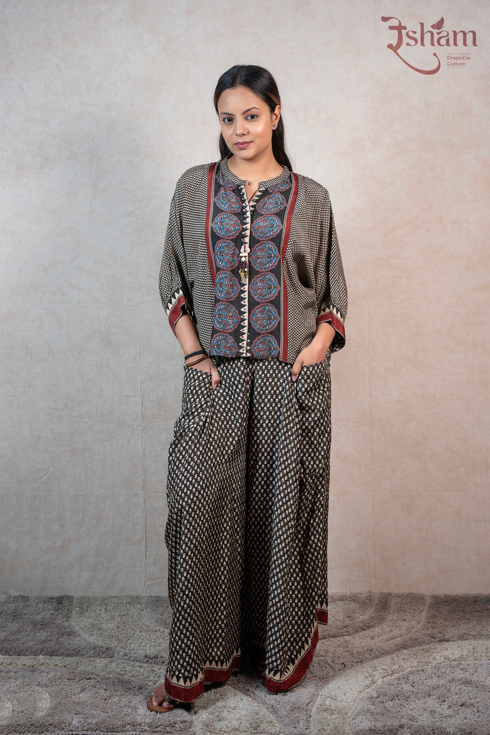 Raysham Fashion printed co-ord set with a geometric floral top and wide-leg trousers in black, red, and blue tones.