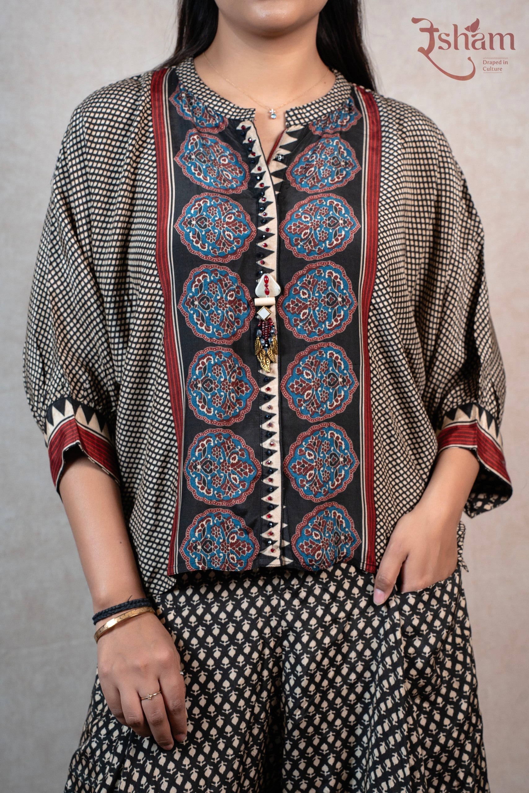 Raysham Fashion printed co-ord set featuring a black top with geometric patterns, floral motifs, and wide-leg trousers.