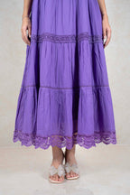 Raysham Fashion purple tiered midi dress with intricate lace trim and side pockets, worn with sparkly bow sandals.