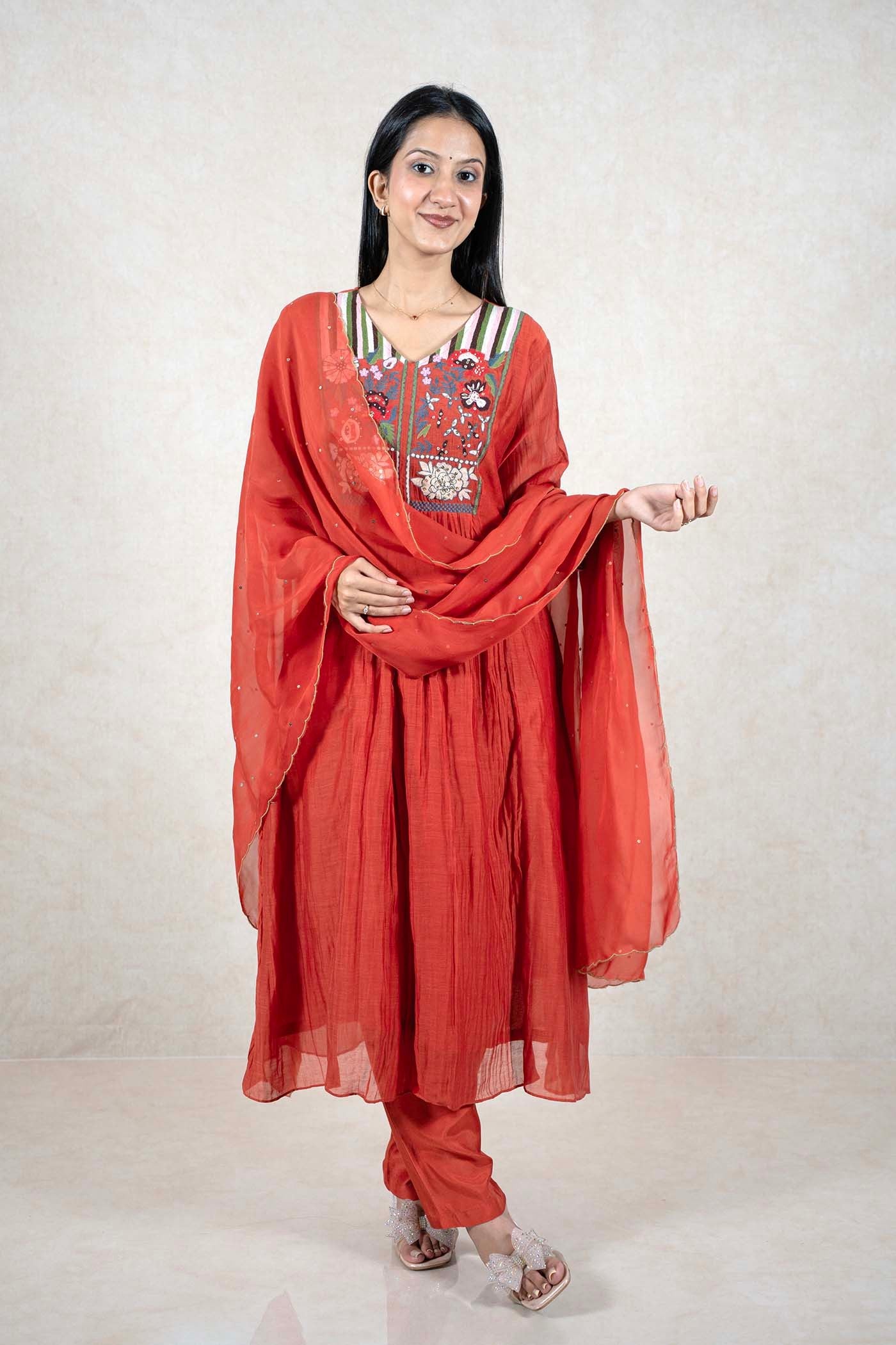 Raysham Fashion rust-orange ethnic kurta set with floral embroidered yoke, sequin accents, and matching dupatta.