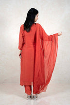Raysham Fashion rust-orange three-piece kurta set with sheer embellished dupatta worn by a woman from behind