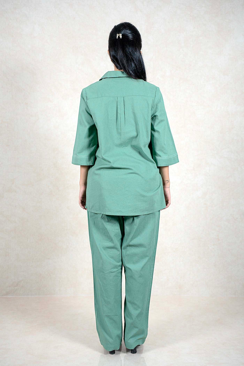 Back view of a woman wearing a Raysham Fashion sage green two-piece co-ord set with three-quarter sleeves
