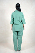 Back view of a woman wearing a Raysham Fashion sage green two-piece co-ord set with three-quarter sleeves