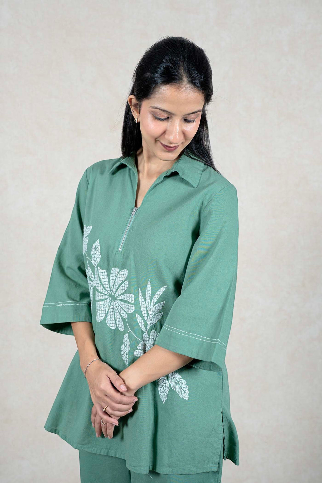 Raysham Fashion sage green two-piece co-ord set with zip-front tunic, three-quarter sleeves, and white floral print.
