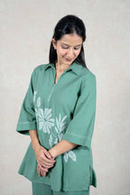 Raysham Fashion sage green two-piece co-ord set with zip-front tunic, three-quarter sleeves, and white floral print.