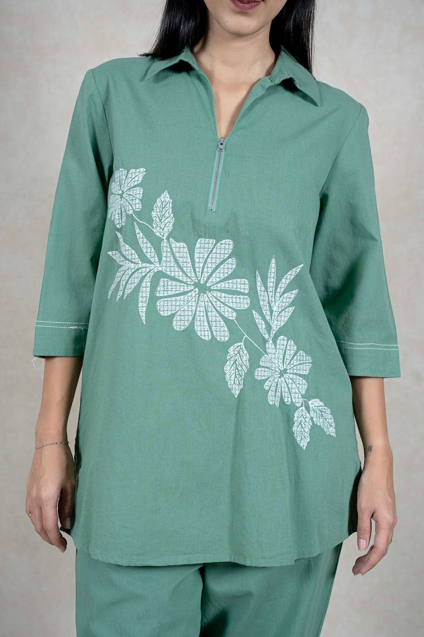 Raysham Fashion sage green two-piece co-ord set featuring a zip-front tunic with white floral print and 3/4 sleeves.