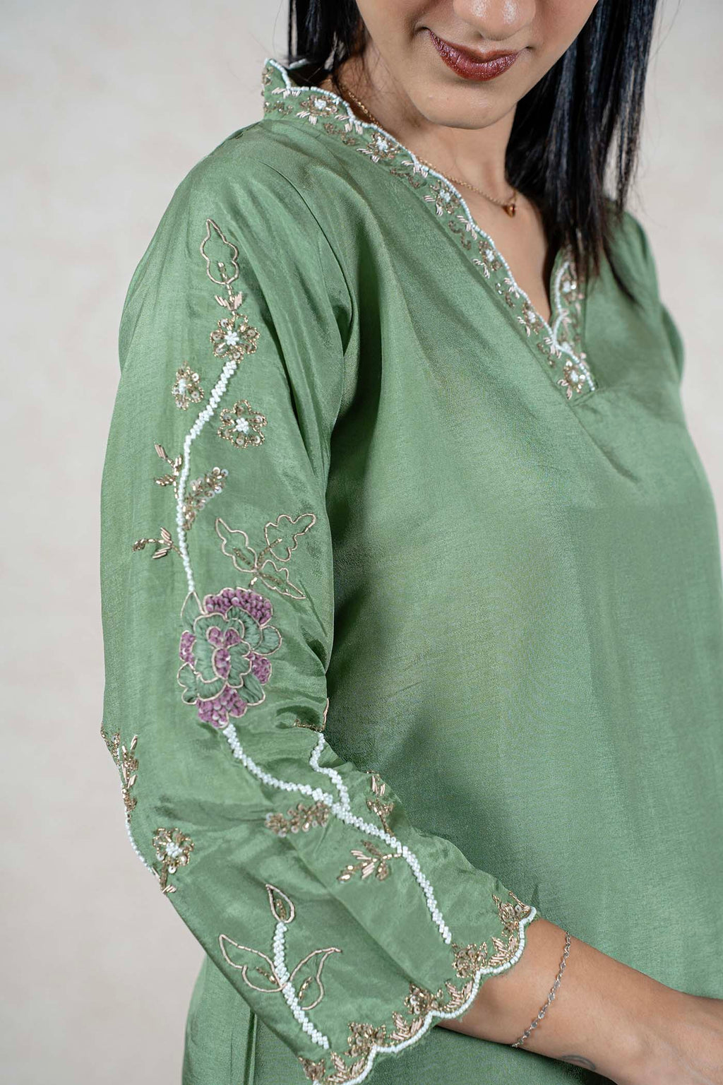Raysham Fashion sage green silk kurta featuring intricate floral embroidery, beadwork, and a V-neckline on a model.