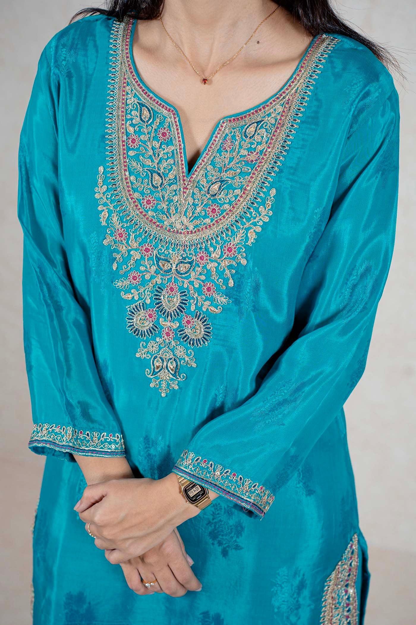 Raysham Fashion teal silk kurta featuring intricate multi-colored floral embroidery on the neckline and sleeve cuffs.