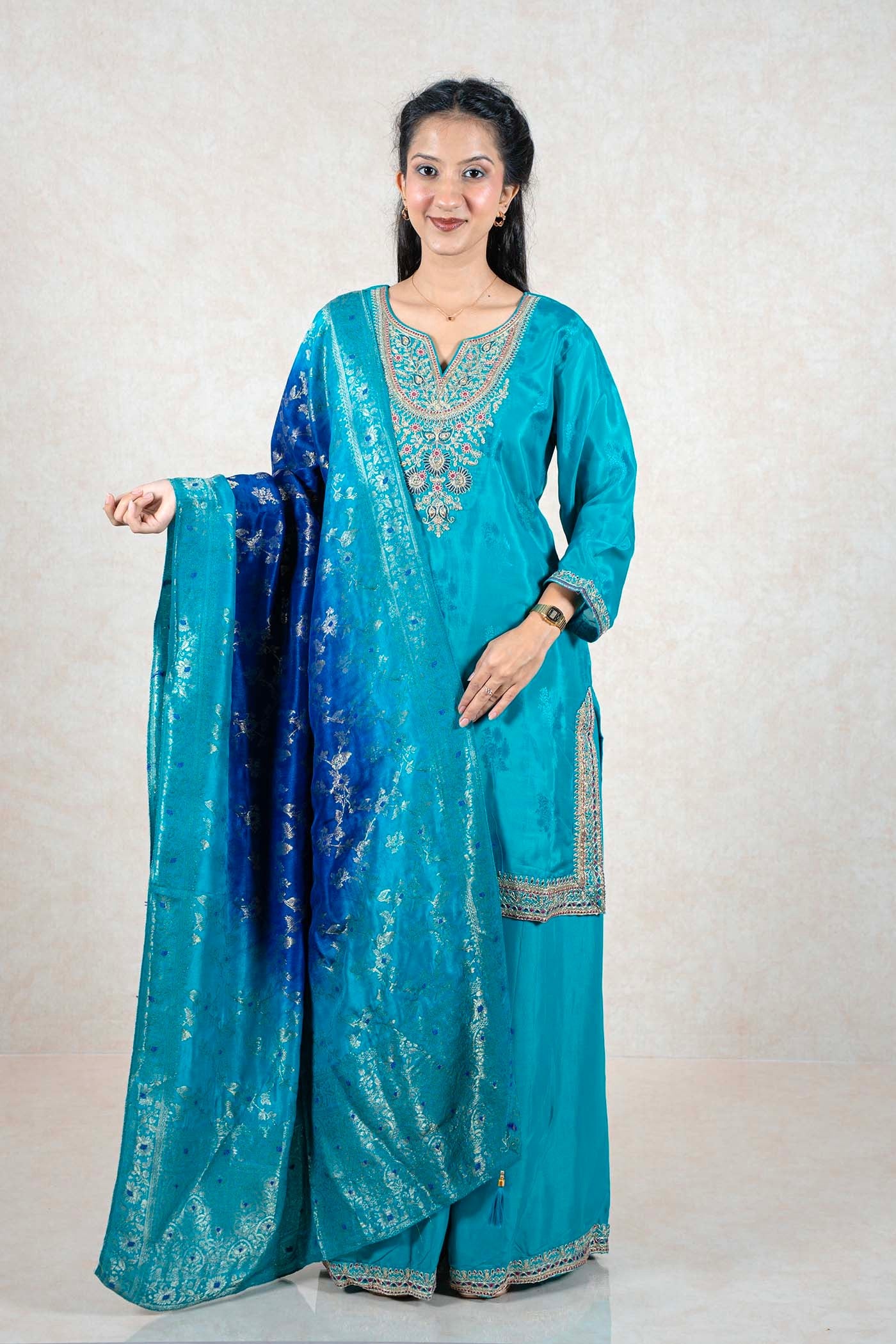 Raysham Fashion teal silk kurta set with multi-colored embroidery and an ombre blue dupatta with silver foil work.