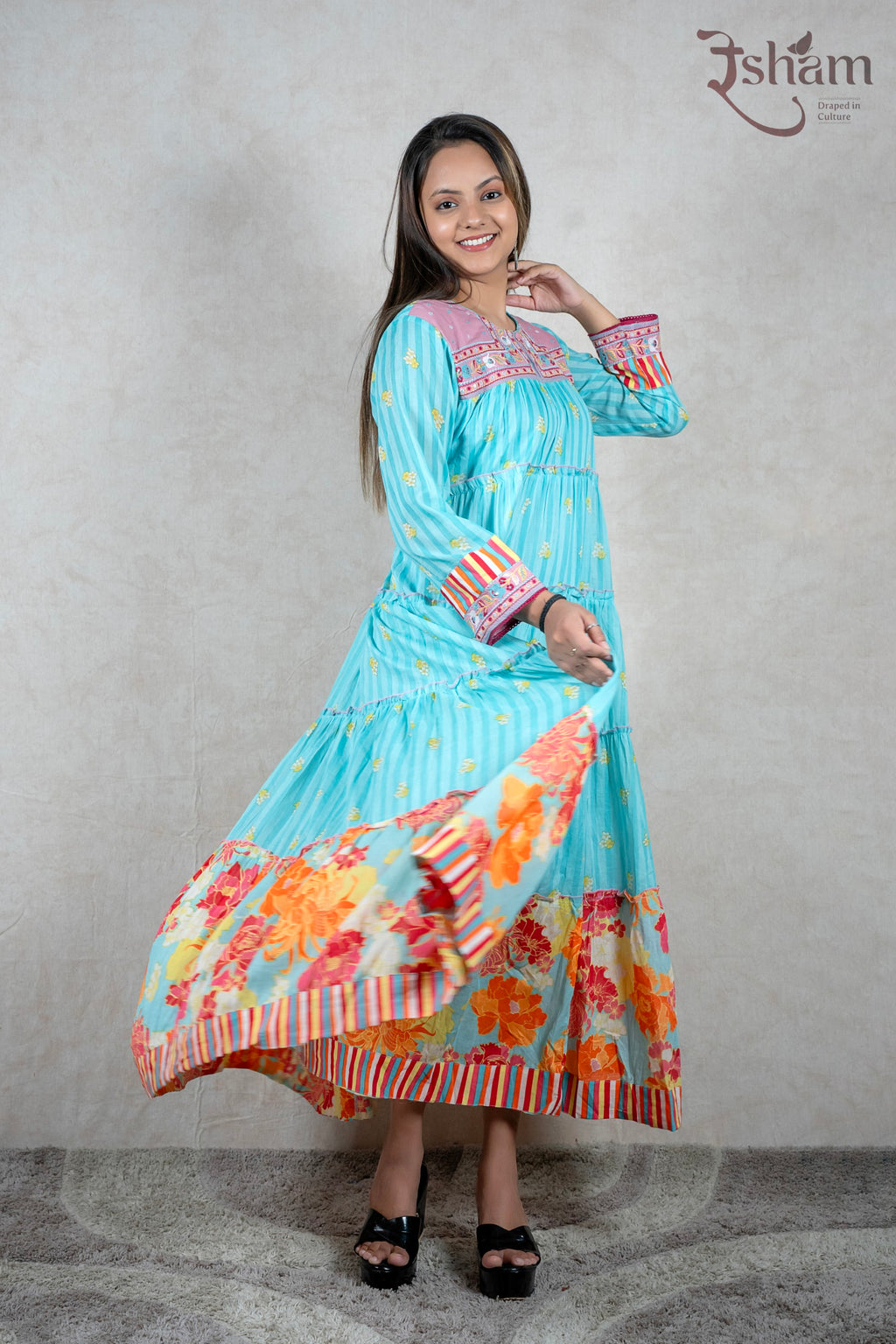 Raysham Fashion turquoise tiered maxi dress with floral print, pink embroidered yoke, and striped cuffs on a model