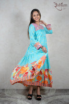 Raysham Fashion turquoise tiered maxi dress with floral print, pink embroidered yoke, and striped cuffs on a model